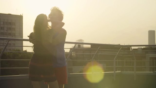 Silhouettes of young couple dancing on sunset