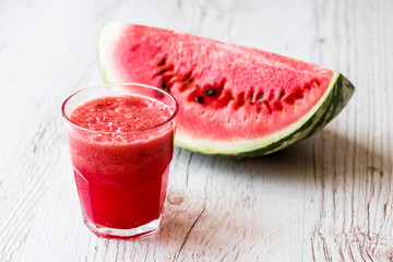 healthy drink. watermelon smoothie in glass on white wooden background