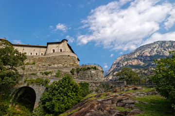 Fototapeta na wymiar Fort Bard, Valle d'Aosta, Italy - August 18, 2017: Historic military construction defence Fort Bard. Touristic medieval fortress in Italian Alps. Location of the Avengers: Age of Ultron film.