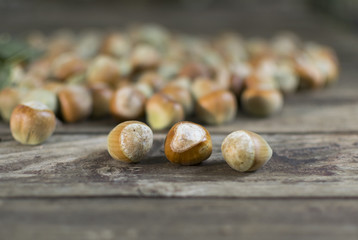 Hazelnuts on wooden table, selective focus