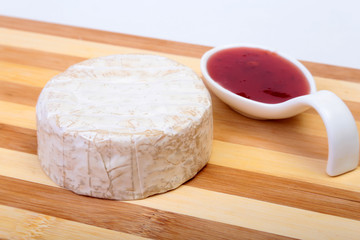 Cheese with white mold. Camembert or brie type with Cranberry sauce.. Healthy breakfast.