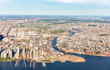 Fototapeta premium Aerial view of Brooklyn and Queens, New York City with East river in the foreground