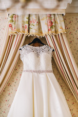 Wedding dress hanging in bridal suite