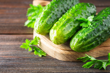 Fresh raw green cucumbers on a wooden table