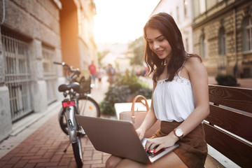 Fototapeta na wymiar Portrait of attractive young girl using laptop