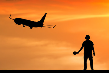 Fototapeta na wymiar Silhouette of employee work for airplane departing flight at the airport
