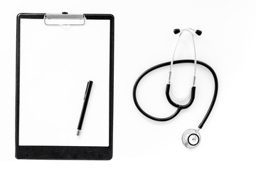 Doctor's accessories. Clip pad and stethoscope on white background top view mockup