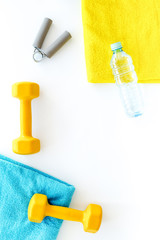 Equipment for fitness. Dumbbells and expander on white background top view copyspace