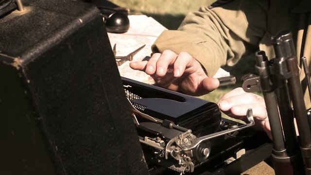 World War Two - Communications officer typing on typewriter at army base V2