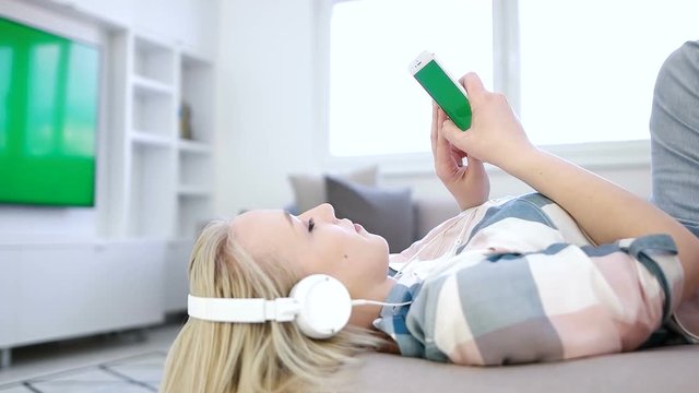 woman relaxing on coutch and listening music