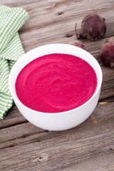creamy beet soup on rustic background