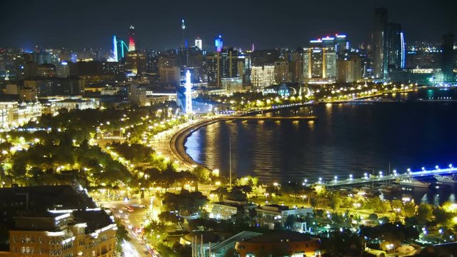 Top View of a Big City by the Sea at Night. Baku, Azerbaijan. Time Lapse. Panorama of the city near the sea, view from above. View from above on the embankment, Caspian Sea, skyscrapers, high-rise