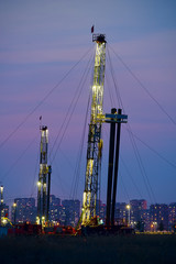 The oil derrick of oil field sunset