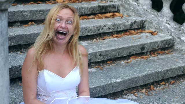 The ghost of the bride wanders through the ruins of the old castle. Bride of the Zombie. 4 k. Slow-motion shooting
