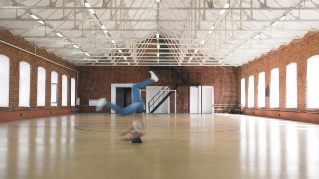 Breakdancer spinning on head in sport gym