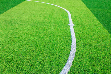 Photo of a green synthetic grass sports field with white line shot from above