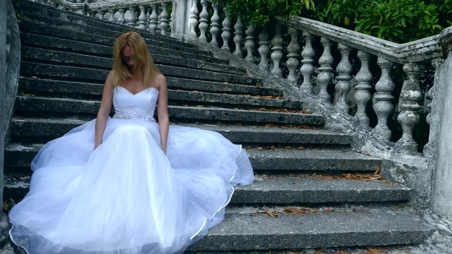 The ghost of the bride wanders through the ruins of the old castle. Bride of the Zombie. 4 k. Slow-motion shooting