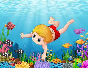 Little boy swimming under the sea