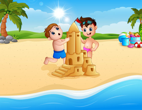 Two boy making sand castle at the beach