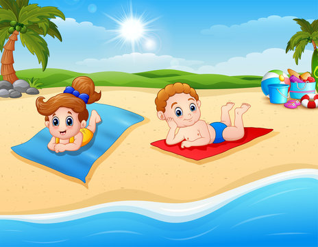 Children sunbathing on the beach mat