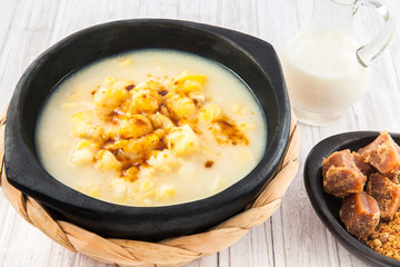 Traditional Colombian corn mazamorra served in black ceramic dish