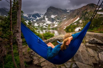 Gordijnen Woman relaxes on a hammock lake Isabelle Colorado © Krzysztof Wiktor