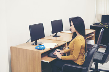 Young woman using computer at office.