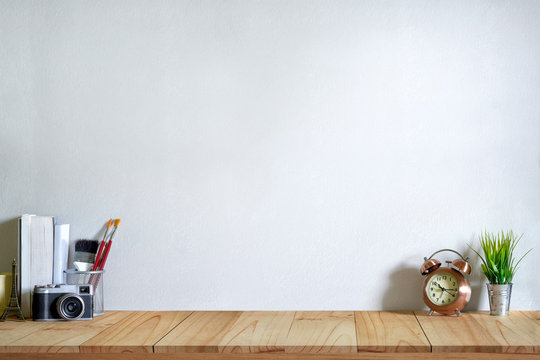 Mock up modern home decor with camera, dummy, houseplant. Artist workspace with copy space for products display montage.
