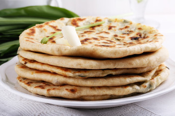 Khychiny – traditional caucasian flatbread filled with сheese and herbs.  Flat bread stuffed with feta and wild garlic.