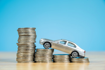 miniature car model on stack of coins