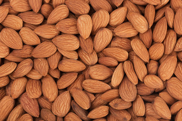 Pile of almonds close-up as background.