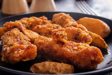 Chicken nuggets on a black plate. closeup