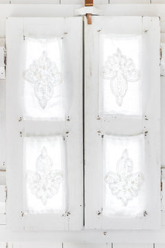 interior of light modern wooden house inside, vintage window with shutters and decorative curtains. Rustic and village style
