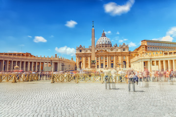 Fototapeta na wymiar St. Peter's Square and St. Peter's Basilica, Vatican City in the day time, tourist around. Italy.