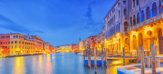 Views of the most beautiful canal of Venice - Grand Canal water streets, boats, gondolas, mansions along. Night view. Italy.