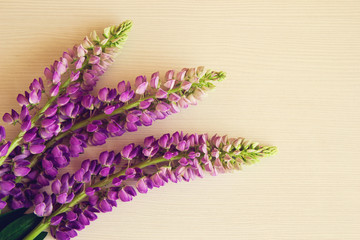 Purple flowers of lythrum on the white wooden background. Toned.