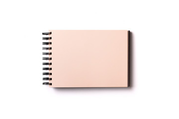 Horizontal aligned isolated sketchbook mock up with blank yellow sheets on white background. Top view, flat lay.