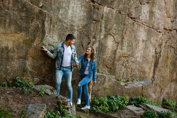 Lovers in jeans walk and laugh at the rocks, canyon