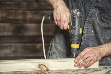 worker  screw with a black modern screwdriver