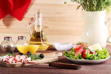 Crab sticks in plate on brown wooden table