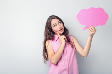 Young woman with speech bubble on grey background