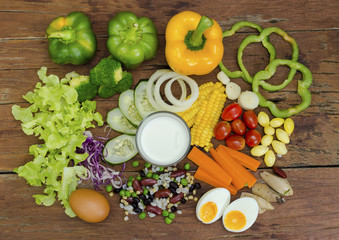 Mix vegetable salad with egg,milk on wood table