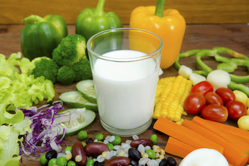 Mix vegetable salad with egg,milk on wood table