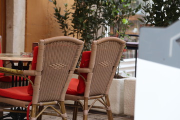 Wicker chairs stand on the terrace