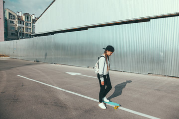 Pre teen skater on the city street