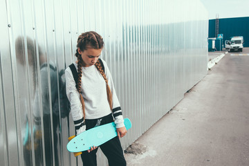 Pre teen skater on the city street