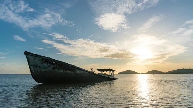 4-K Time lapse of shipwreck on beach in the andaman sea with beautiful sunrise or sunset in phuket thailand