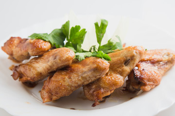 chicken wings with greens on the plate