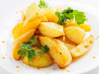 baked potatoes with greens and spices on the plate