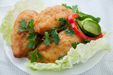 Beef cutlets with greens and vegetables on the plate